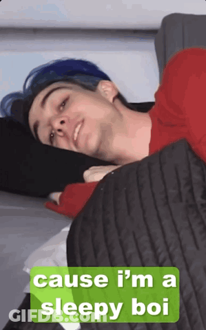 Man With Blue Hair Laying On Bed Saying Cause I'm A Sleepy Bo GIF