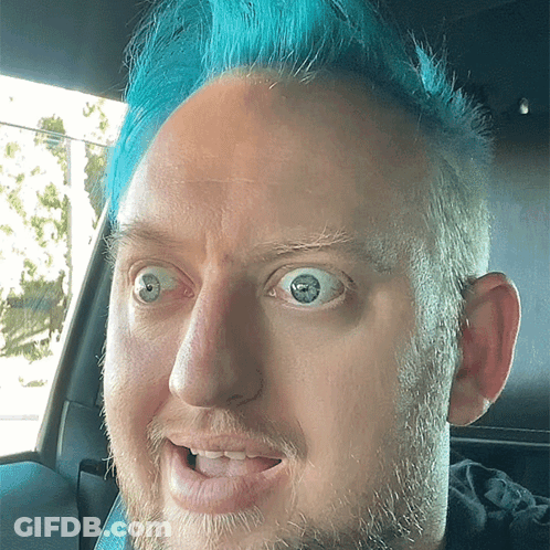 Man With Blue Hair Making Funny Face In Car GIF