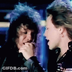 Man With Blue Hair Singing Into Microphone Next To Another Man GIF