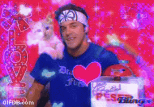 Man With Blue Heart Shirt Holding Stuffed Animal GIF