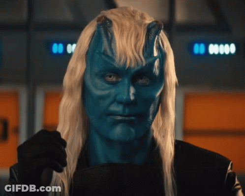 Man With Blue Paint On Face And Long Blonde Hair GIF