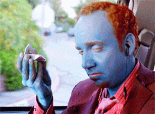 Man With Blue Paint On Face Holding Small Object GIF
