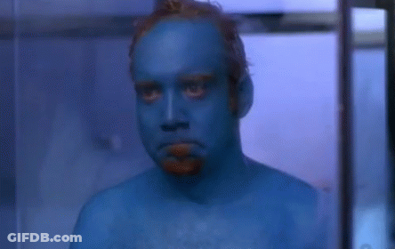 Man With Blue Painted Face Looking At Camera GIF