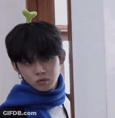 Man With Blue Scarf And Green Plant On Head GIF