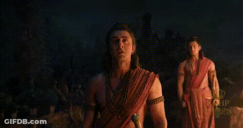Man With Bow And Arrow Standing In Hut GIF