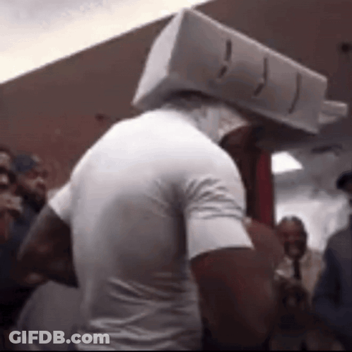 Man With Box On Head In Crowd GIF