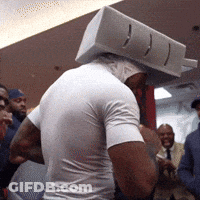 Man With Box On Head In Front Of Crowd GIF