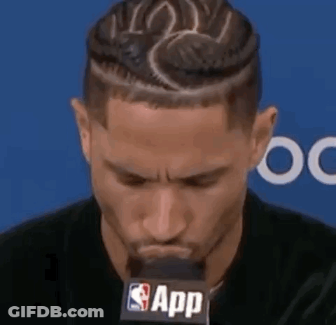 Man With Braided Hairstyle At Microphone GIF