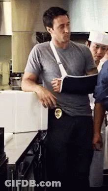 Man With Broken Arm In Cast In Kitchen GIF
