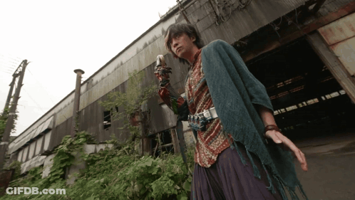 Man With Camera On Arm At Building GIF