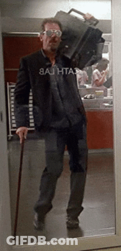 Man With Cane Carrying Suitcase And Bathta GIF