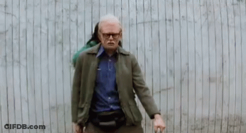Man With Cane Standing In Front Of Wooden Wall Saying Forever GIF