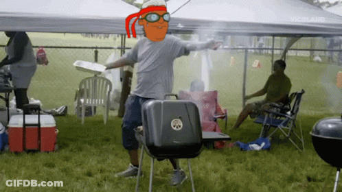 Man With Cartoon Character On Head Standing In Front Of Grill GIF