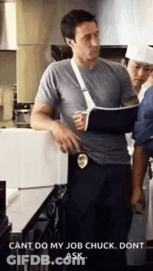 Man With Cast On Arm In Kitchen With Others GIF