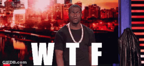 Man With Chain Standing Before WTF Sign GIF