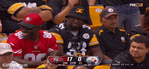 Man With Chain Watching Football In Stadium GIF