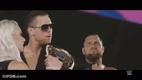 Man With Championship Belt Next To Woman And Bearded Man GIF