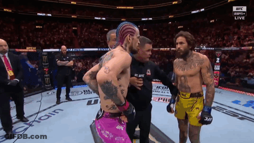 Man With Chest Tattoo And Another In UFC Ring GIF