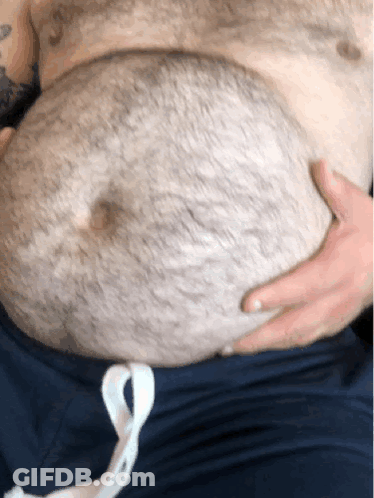Man With Chest Tattoo Holding Stomach GIF