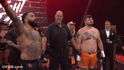 Man With Chest Tattoo In Boxing Ring With Referee GIF
