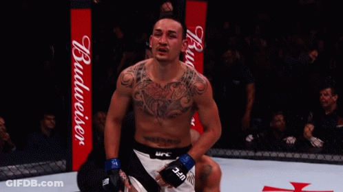 Man With Chest Tattoo In Front Of Budweiser Sign GIF