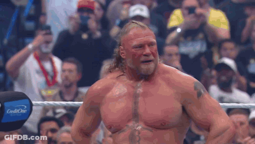 Man With Chest Tattoo In Wrestling Ring With Crowd GIF