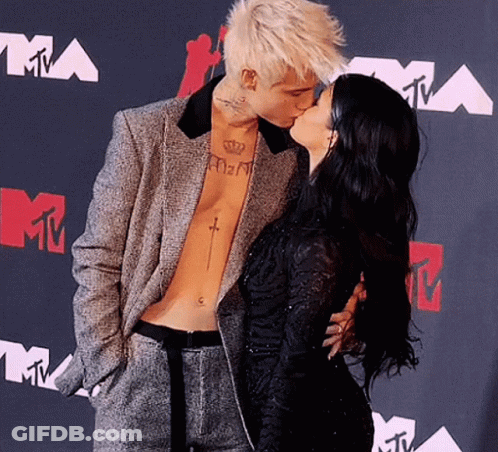 Man With Chest Tattoo Kissing Woman GIF