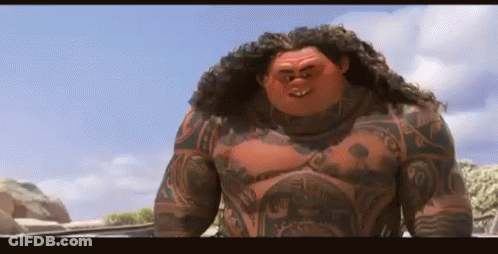Man With Chest Tattoo On Rocky Beach GIF