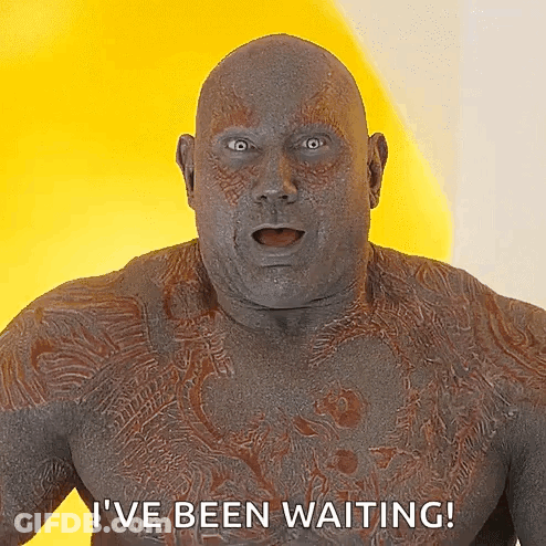 Man With Chest Tattoo Saying I've Been Waiting On Yellow Background GIF