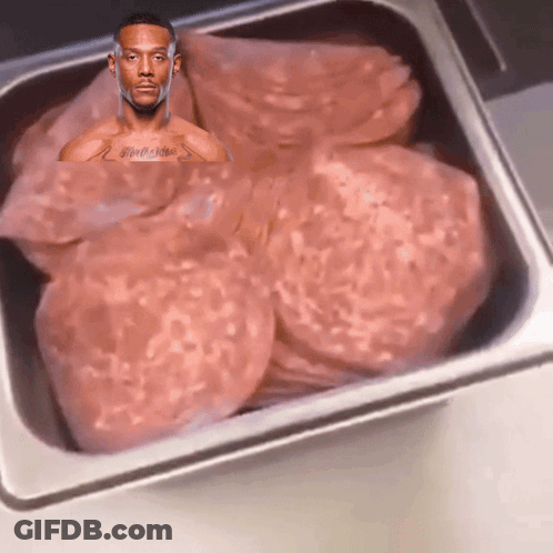 Man With Chest Tattoo Sitting In Meat Tray GIF