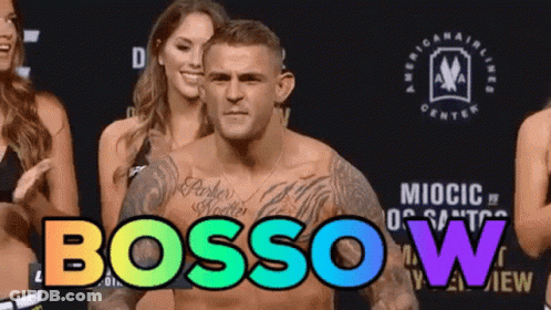 Man With Chest Tattoo Standing Before Women Bossow GIF