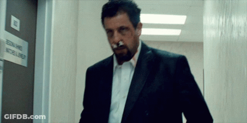 Man With Cigarette Walks Past Edna James Sign GIF