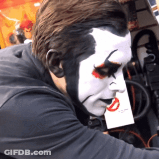 Man With Clown Face Holding Paper GIF