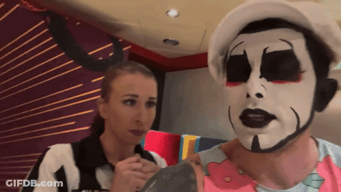 Man With Clown Face Next To Woman GIF
