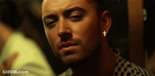 Man With Cross Earring Looking At Camera GIF