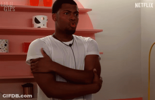 Man With Crossed Arms At Pink Netflix Shelf GIF