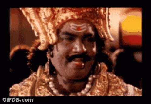 Man With Crown And Mustache Looking At Camera GIF