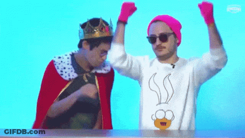 Man With Crown Beside Man In Cartoon Sweater GIF