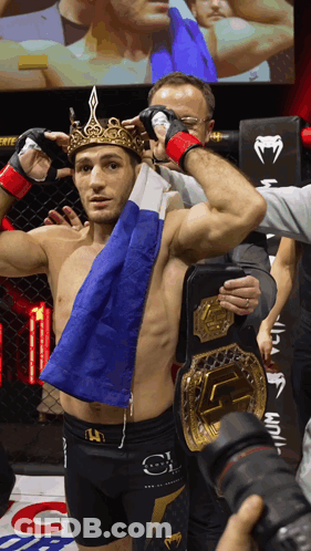 Man With Crown Holding Flag And UFC Belt GIF