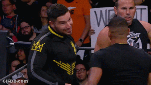 Man With Crown Jacket In Front Of Sign Saying W GIF