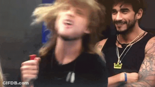 Man With Crown Necklace Next To Another Man GIF