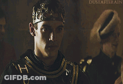 Man With Crown Standing In Front Of Dustaterrain Sign GIF