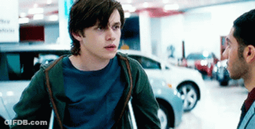 Man With Crutches Talking To Man In Car Showroom GIF