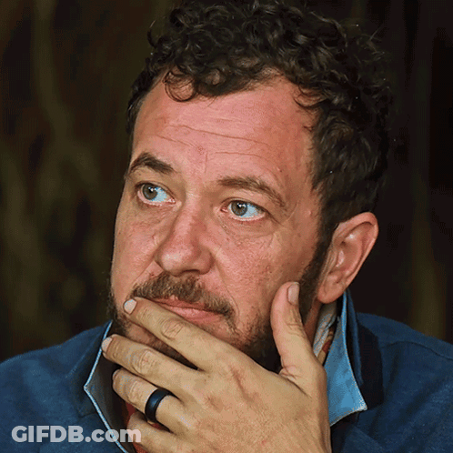 Man With Curly Hair And Beard Hand On Chin GIF