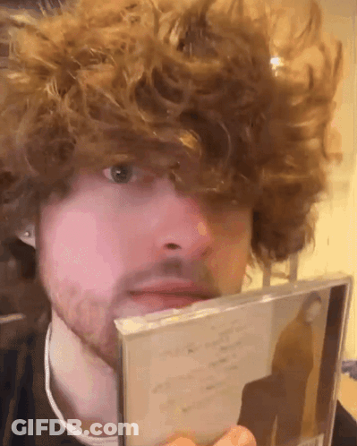 Man With Curly Hair And Beard Holding CD GIF
