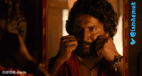 Man With Curly Hair And Beard In Front Of Twitter Logo GIF