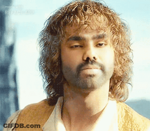 Man With Curly Hair And Beard Looking At Camera GIF