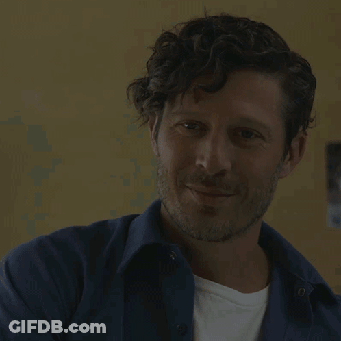 Man With Curly Hair And Beard Smiling GIF