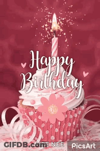 Man With Curly Hair And Beard Smiling In Front Of Candles GIF