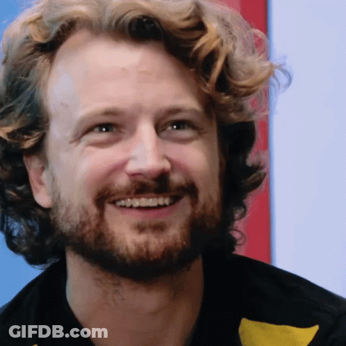 Man With Curly Hair And Beard Smiling GIF